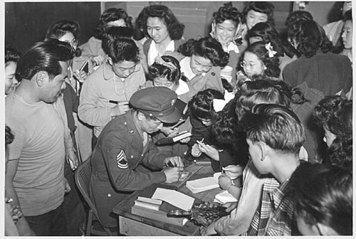 Kuroki swamped by autograph seekers.