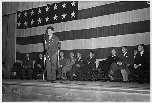 Sgt. Kuroki delivers an address in the auditorium of Heart Mountain High School.
