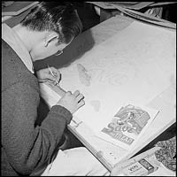 Photo of Yosh Kuromiya at his drafting table.