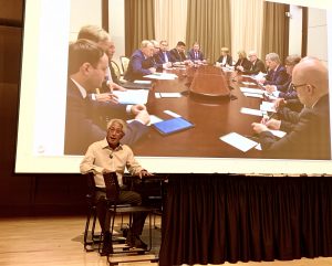 Shawn Wong with photo of conference table
