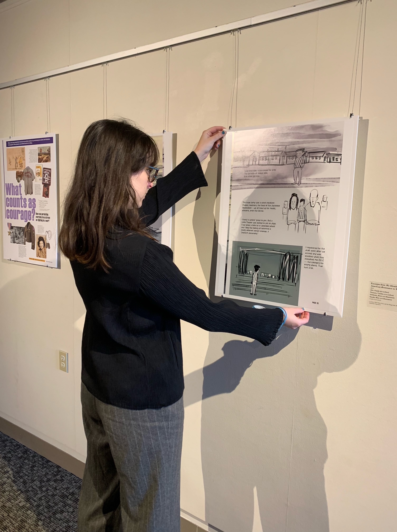 curator hanging artwork