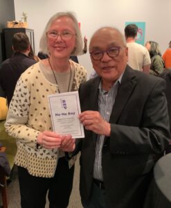 two people holding program