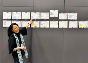 woman at wall with papers